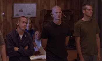 Movie still from “The Believer” (2001), directed by Henry Bean – A group of people standing in a living room; Medium shot, Low angle