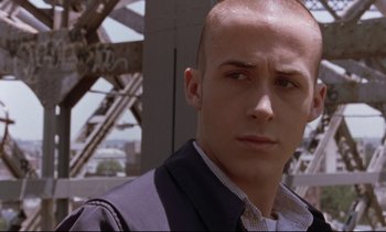 Movie still from “The Believer” (2001), directed by Henry Bean – A person wearing a suit and tie; Close Up shot, Low angle