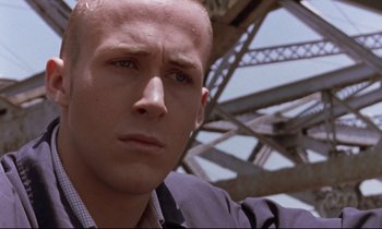 Movie still from “The Believer” (2001), directed by Henry Bean – A person wearing a suit and tie; Close Up shot, Low angle