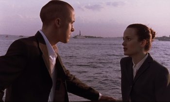 Movie still from “The Believer” (2001), directed by Henry Bean – A man and a woman standing next to a body of water; Medium shot, Low angle