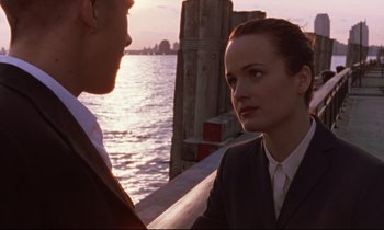 Movie still from “The Believer” (2001), directed by Henry Bean – A man and a woman standing next to a body of water; Close Up shot, Over the shoulder angle