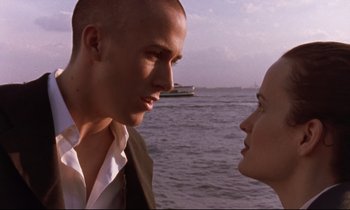 Movie still from “The Believer” (2001), directed by Henry Bean – A man and a woman face to face in front of a body of water; Close Up shot, Over the shoulder angle