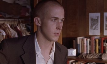 Movie still from “The Believer” (2001), directed by Henry Bean – A man in a suit is looking to his left; Close Up shot, Low angle