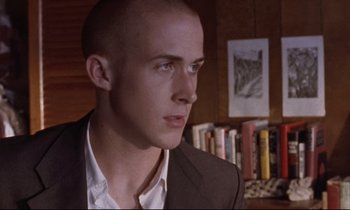 Movie still from “The Believer” (2001), directed by Henry Bean – A man in a suit looking to his left; Close Up shot, Low angle