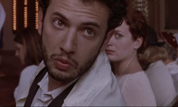Movie still from “The Believer” (2001), directed by Henry Bean – A person with a towel on their head; Close Up shot, Over the shoulder angle