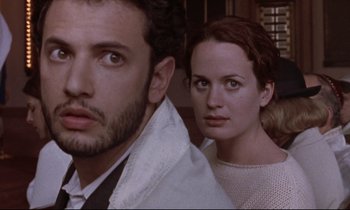 Movie still from “The Believer” (2001), directed by Henry Bean – A man and a woman standing next to each other; Close Up shot, Over the shoulder angle