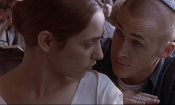 Movie still from “The Believer” (2001), directed by Henry Bean – A man and a woman looking at one another; Close Up shot, Over the shoulder angle