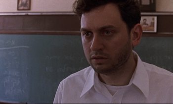 Movie still from “The Believer” (2001), directed by Henry Bean – A man in a white dress shirt is looking at the camera; Close Up shot, Low angle