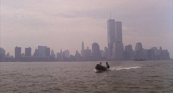 Movie still from “The Believers” (1987), directed by John Schlesinger – Two people in a boat on a body of water; Extreme Wide shot, High angle