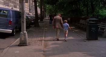 Movie still from “The Believers” (1987), directed by John Schlesinger – A man and a boy walking down a sidewalk; Wide shot, High angle