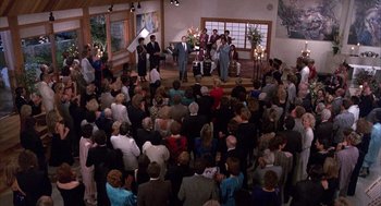 Movie still from “The Believers” (1987), directed by John Schlesinger – A large group of people gathered in a large room; Extreme Wide shot, High angle
