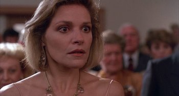 Movie still from “The Believers” (1987), directed by John Schlesinger – A person wearing a necklace; Close Up shot, Low angle