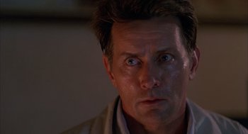 Movie still from “The Believers” (1987), directed by John Schlesinger – A person looking at the camera; Close Up shot, Low angle