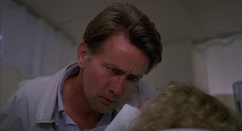 Movie still from “The Believers” (1987), directed by John Schlesinger – A person looking down at something; Close Up shot, Low angle