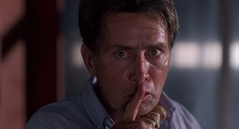 Movie still from “The Believers” (1987), directed by John Schlesinger – A person holding a wooden spoon in his mouth; Close Up shot, Low angle