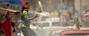 Movie still from “The Belko Experiment” (2016), directed by Greg McLean – A young man is playing with a frisbee in the street; Medium shot, Low angle