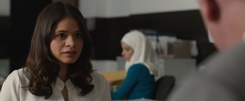 Movie still from “The Belko Experiment” (2016), directed by Greg McLean – A woman with a head covering sitting next to another woman; Close Up shot, Over the shoulder angle