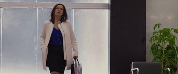 Movie still from “The Belko Experiment” (2016), directed by Greg McLean – A woman in a white jacket holding a purse; Medium shot, Low angle