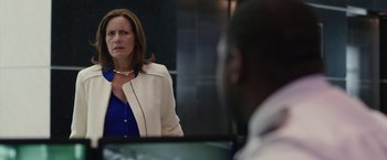 Movie still from “The Belko Experiment” (2016), directed by Greg McLean – A woman standing in front of a mirror in front of a man; Close Up shot, Over the shoulder angle