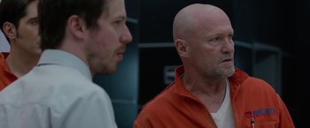 Movie still from “The Belko Experiment” (2016), directed by Greg McLean – A man with a shaved head and a man with a shaved head; Close Up shot, Over the shoulder angle