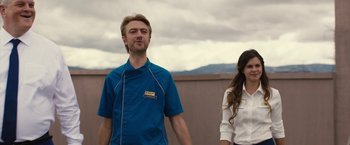 Movie still from “The Belko Experiment” (2016), directed by Greg McLean – A man and a woman standing next to each other; Medium shot, Low angle