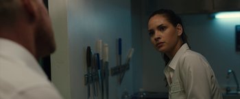 Movie still from “The Belko Experiment” (2016), directed by Greg McLean – A woman standing in front of a wall with toothbrushes on the wall; Close Up shot, Over the shoulder angle