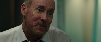 Movie still from “The Belko Experiment” (2016), directed by Greg McLean – A person wearing a shirt and tie; Close Up shot, Over the shoulder angle