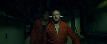 Movie still from “The Belko Experiment” (2016), directed by Greg McLean – Two men in orange jackets standing next to each other; Medium shot, Low angle