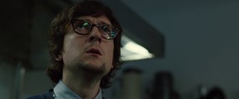 Movie still from “The Belko Experiment” (2016), directed by Greg McLean – A person wearing glasses; Close Up shot, Low angle