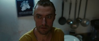 Movie still from “The Belko Experiment” (2016), directed by Greg McLean – A person with his eyes wide open; Close Up shot, Low angle