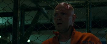 Movie still from “The Belko Experiment” (2016), directed by Greg McLean – A man with a shaved head and a bandage on his head; Close Up shot, Low angle