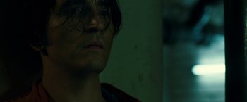 Movie still from “The Belko Experiment” (2016), directed by Greg McLean – A man's face with a dark background; Close Up shot, Low angle