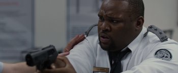 Movie still from “The Belko Experiment” (2016), directed by Greg McLean – A man holding a cell phone up to his ear; Close Up shot, Over the shoulder angle