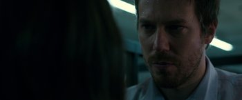 Movie still from “The Belko Experiment” (2016), directed by Greg McLean – A person looking at the camera; Close Up shot, Over the shoulder angle