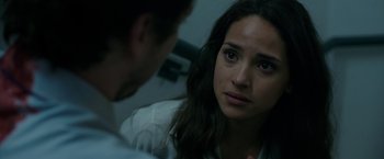 Movie still from “The Belko Experiment” (2016), directed by Greg McLean – A woman sitting in front of a man in a room; Close Up shot, Over the shoulder angle