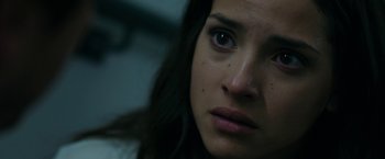 Movie still from “The Belko Experiment” (2016), directed by Greg McLean – A woman's face in a dark room; Close Up shot, Low angle