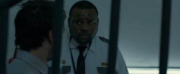 Movie still from “The Belko Experiment” (2016), directed by Greg McLean – A man that is in a jail cell; Close Up shot, Over the shoulder angle