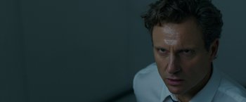 Movie still from “The Belko Experiment” (2016), directed by Greg McLean – A person wearing a white dress shirt; Close Up shot, Over the shoulder angle