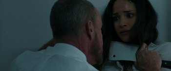 Movie still from “The Belko Experiment” (2016), directed by Greg McLean – A man and a woman looking at one another; Close Up shot, Over the shoulder angle