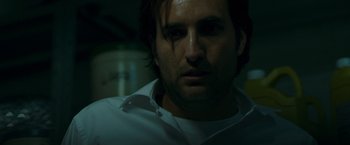 Movie still from “The Belko Experiment” (2016), directed by Greg McLean – A person wearing a white shirt; Close Up shot, Low angle