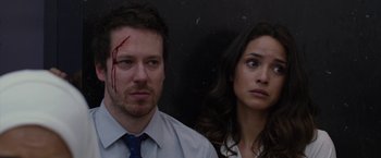 Movie still from “The Belko Experiment” (2016), directed by Greg McLean – A man and a woman looking at the camera; Close Up shot, Low angle