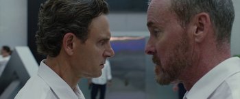 Movie still from “The Belko Experiment” (2016), directed by Greg McLean – Two men face each other in a face - to - face contest; Close Up shot, Over the shoulder angle