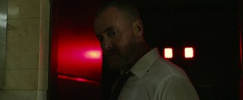 Movie still from “The Belko Experiment” (2016), directed by Greg McLean – A person wearing a shirt and a tie; Close Up shot, Low angle