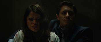 Movie still from “The Belko Experiment” (2016), directed by Greg McLean – A man and a woman sitting next to each other in a dark room; Close Up shot, Low angle