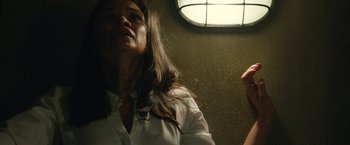 Movie still from “The Belko Experiment” (2016), directed by Greg McLean – A woman in a white dress shirt and a tie; Close Up shot, Low angle