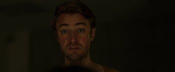 Movie still from “The Belko Experiment” (2016), directed by Greg McLean – A person looking at the camera; Close Up shot, Low angle