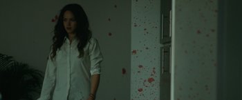 Movie still from “The Belko Experiment” (2016), directed by Greg McLean – A woman standing in front of a wall covered in blood; Medium shot, Low angle