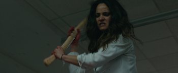 Movie still from “The Belko Experiment” (2016), directed by Greg McLean – A woman holding a baseball bat in a room; Close Up shot, Over the shoulder angle