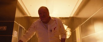 Movie still from “The Belko Experiment” (2016), directed by Greg McLean – An older man with blood on his shirt; Medium shot, Low angle