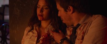 Movie still from “The Belko Experiment” (2016), directed by Greg McLean – A man and a woman with blood all over them; Close Up shot, High angle